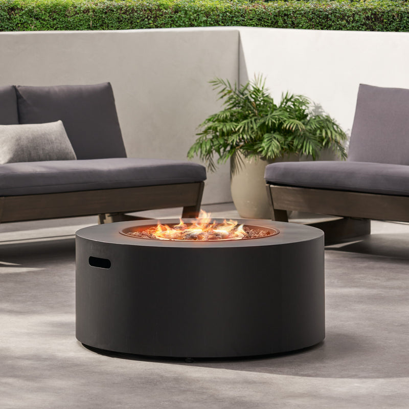 Round Noble House iron fire pit with 40,000 Btu burner, suitable for outdoor heating and cozy gatherings.