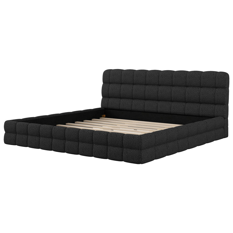 Dreamland upholstered platform bed with padded headboard, showcasing the fabric-covered frame and modern bedroom design.