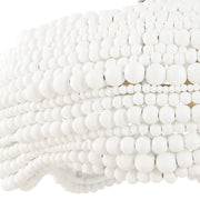 White Biddeford 5-light beaded pendant lighting fixture by Uttermost hanging with beaded detailing and metal accents.