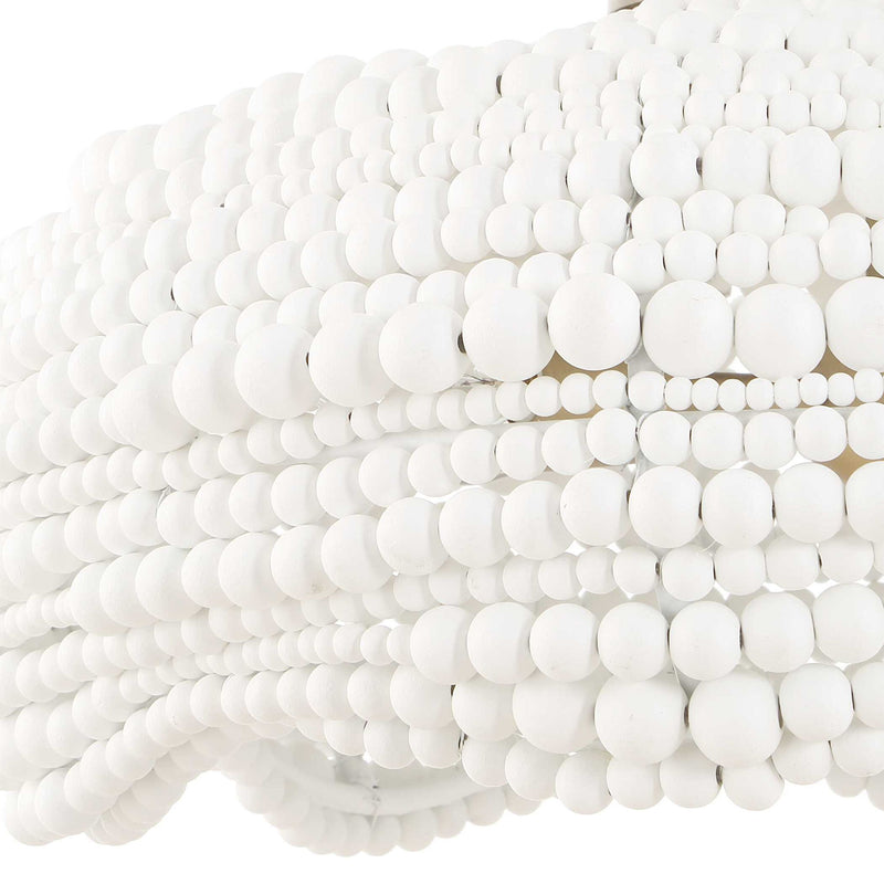 White Biddeford 5-light beaded pendant lighting fixture by Uttermost hanging with beaded detailing and metal accents.