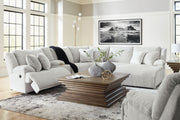 Signature Design by Ashley reclining 6-piece living room set with plush sofas and armchairs, featuring a modern, comfortable design.