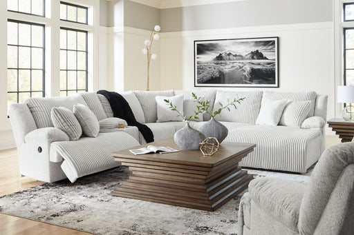 Signature Design by Ashley reclining 6-piece living room set with plush sofas and armchairs, featuring a modern, comfortable design.