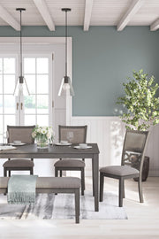 Gray Wrenning dining room table set by Signature Design by Ashley, featuring six matching chairs around a rectangular table.