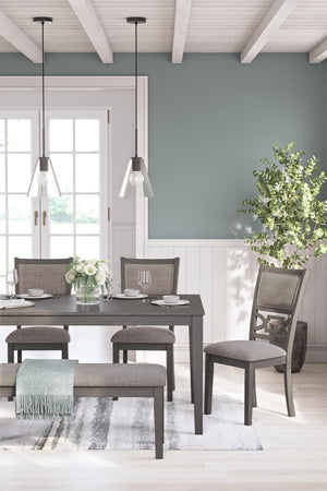 Gray Wrenning dining room table set by Signature Design by Ashley, featuring six matching chairs around a rectangular table.