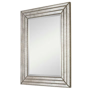 Uttermost Seymour antique silver wall mirror with a sleek, modern frame, reflecting a stylish interior decor.
