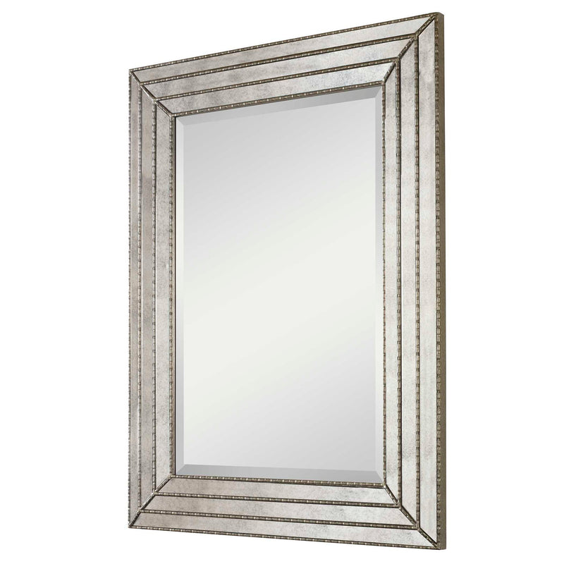 Uttermost Seymour antique silver wall mirror with a sleek, modern frame, reflecting a stylish interior decor.