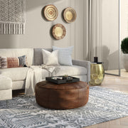 Handcrafted round accent pouf by Simpli-Home with soft fabric upholstery and plush filling, perfect for living room decor.