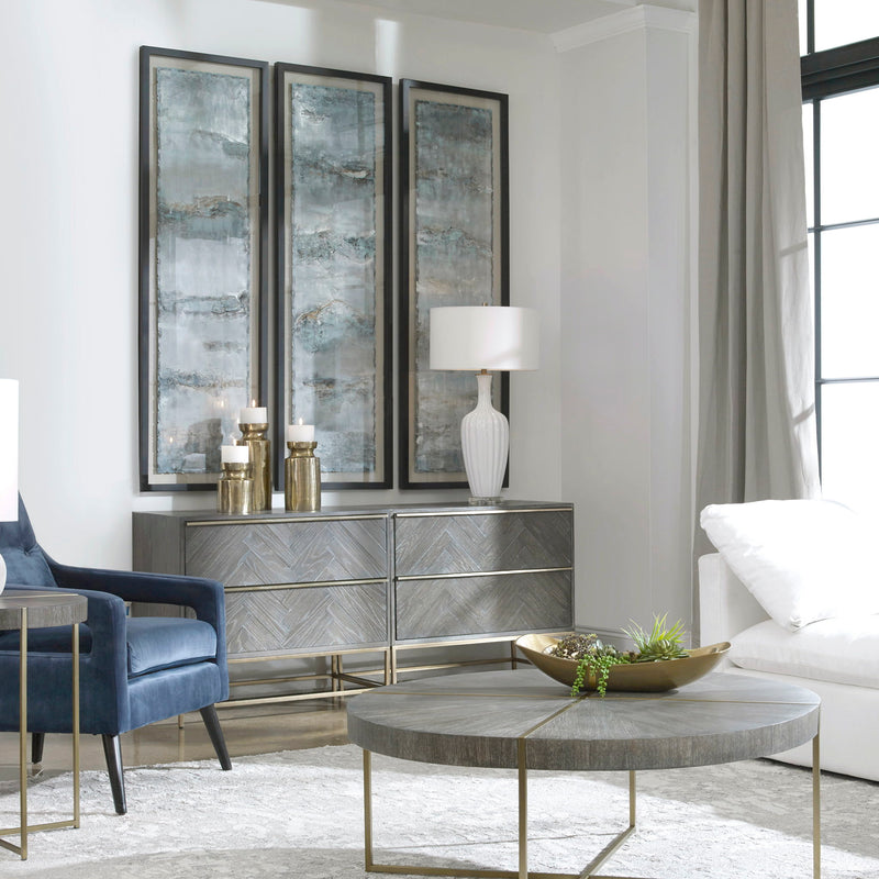 Set of three blue painted metal wall decor panels by Uttermost featuring ocean-inspired swells for coastal home accents.