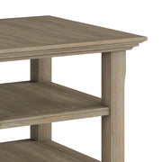 Handcrafted Acadian end table by Simpli-Home featuring a rustic wooden surface and sturdy legs in a cozy living room setting.