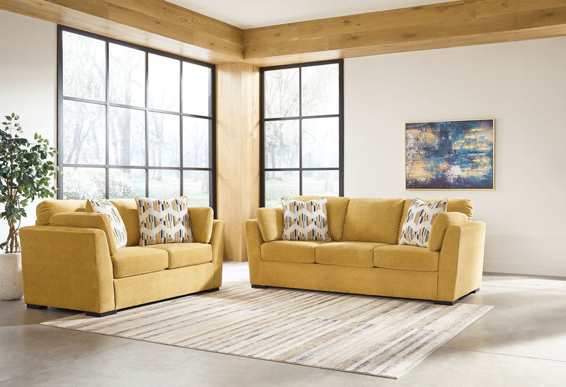 Signature Design by Ashley Keerwick living room set with stationary chair and matching ottoman, featuring plush upholstery and stylish design.