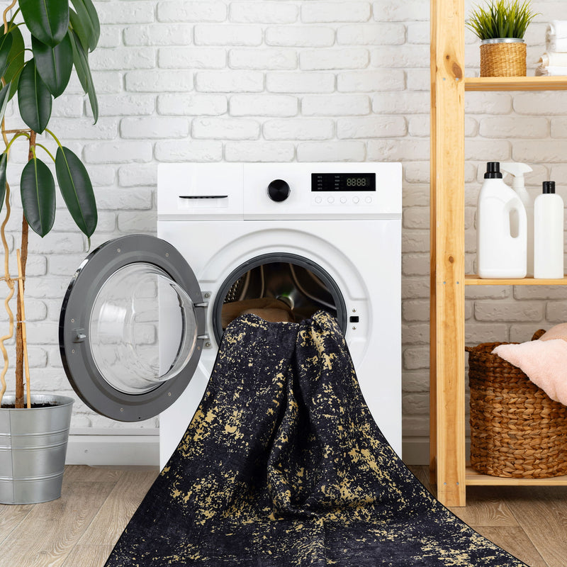Maval - 8' X 10' Washable Area Rug - Black / Gold - R&R Furniture Gallery (Fountain Valley, CA)