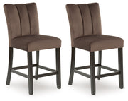 Pair of Jeshina upholstered barstools in mocha by Signature Design, featuring cushioned seats and wooden legs for stylish seating.