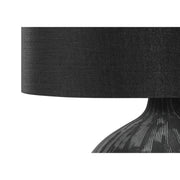 Contemporary black ceramic table lamp with a sleek design, perfect for modern living spaces.