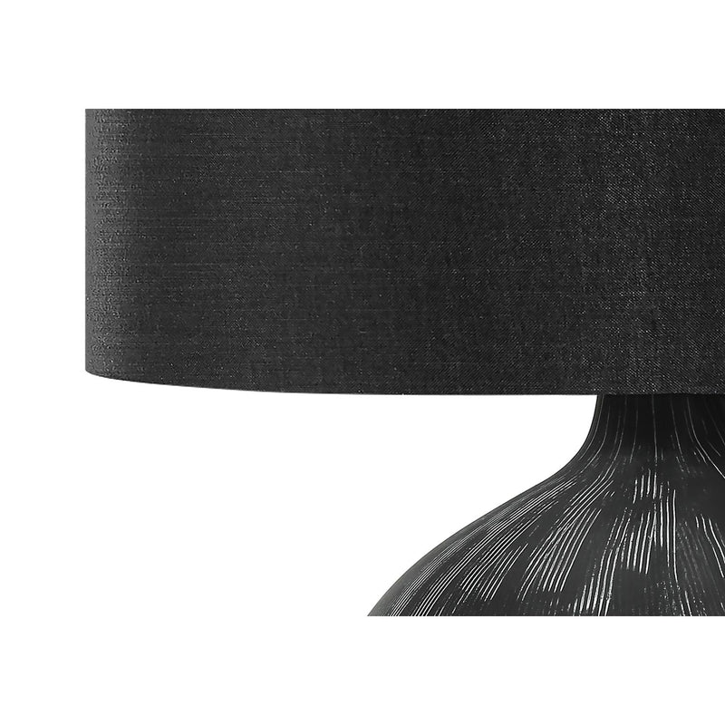 Contemporary black ceramic table lamp with a sleek design, perfect for modern living spaces.