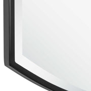 Black shield-shaped iron wall mirror by Uttermost with a bold, artistic design and reflective glass surface.