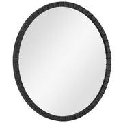 Round industrial wall mirror by Uttermost with a metal frame, perfect for modern or industrial home decor.