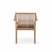 Noble House 5-piece outdoor patio furniture set with acacia wood table and four heavy-duty cushioned chairs in a garden setting.