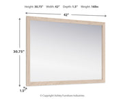 Signature Design by Ashley bedroom mirror from Cadmori collection, rectangular with a sleek wooden frame.