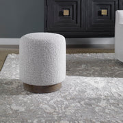 Uttermost Avila accent ottoman with textured fabric and wooden legs, versatile piece for living room or bedroom decor.