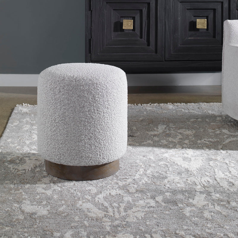 Uttermost Avila accent ottoman with textured fabric and wooden legs, versatile piece for living room or bedroom decor.
