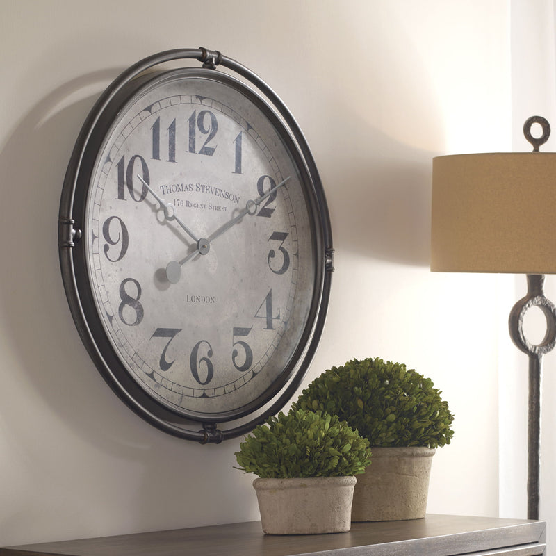 Nakul industrial wall clock by Uttermost featuring a pearl silver finish with bold black hands on a round metal frame.