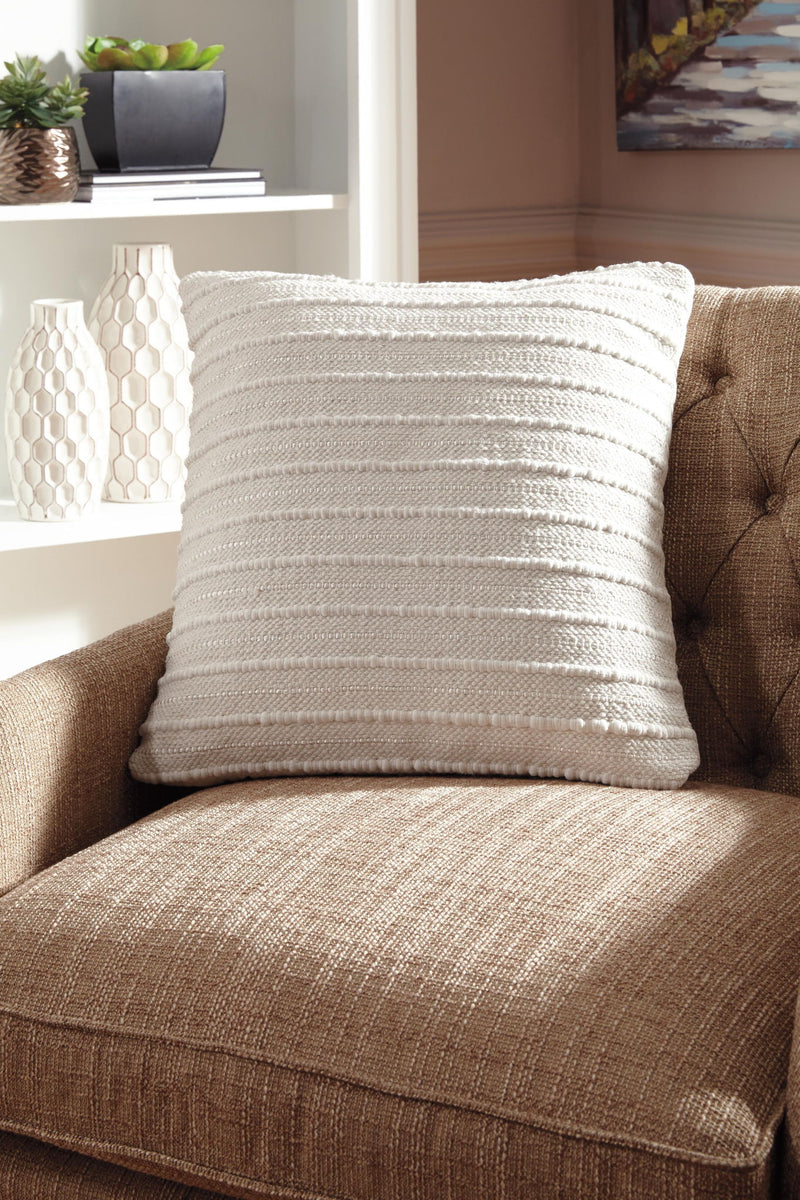 Theban throw pillow from Signature Design by Ashley features a soft fabric cover with decorative stitching, perfect for living room decor.