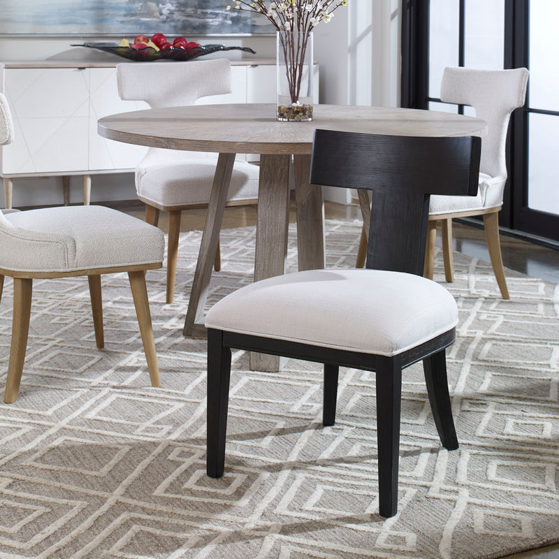 Uttermost Idris armless side chair with plush upholstery and sleek wooden legs, modern design for living or dining room.