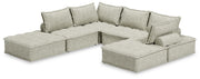 Signature Design by Ashley stationary sectional sofa with beige fabric and plush cushions in a modern living room setting.