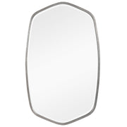 Uttermost Duronia iron wall mirror with a sleek, round frame hanging on a wall, reflecting a modern interior.