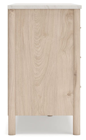 Signature Design by Ashley Cadmori six-drawer dresser with dark wood finish and modern handles, showcasing spacious storage.
