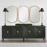 Uttermost Duronia iron wall mirror with sleek, modern frame reflecting light and adding contemporary style to a room.