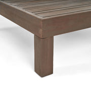 Rustic gray Noble House Oana Brava coffee table with slat panel design, showcasing a sturdy wooden construction and modern style.
