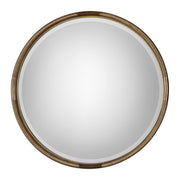 Uttermost Finnick iron coil round wall mirror with a gold finish, showcasing a stylish circular design and metallic frame.
