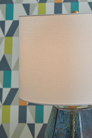 Blue glass table lamp from Signature Design by Ashley® with a sleek, modern design and clear glass base.