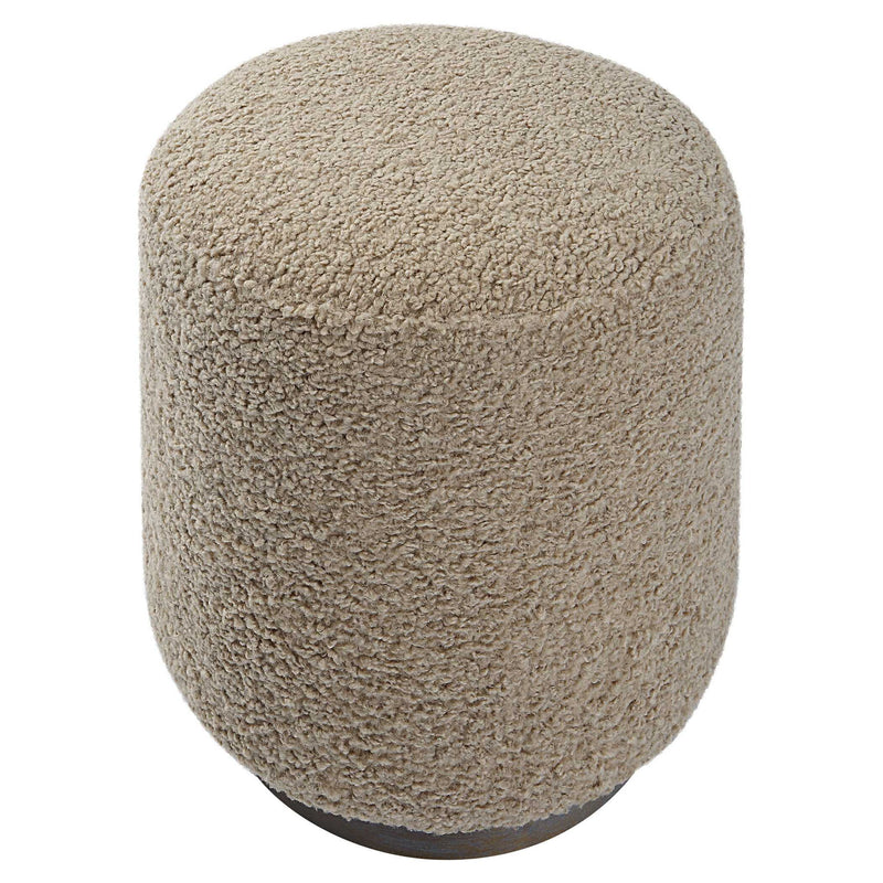 Uttermost Avila accent ottoman with plush fabric and wooden legs, serving as a stylish footrest or additional seating.