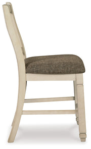 Set of two beige upholstered barstools by Signature Design by Ashley®, featuring cushioned seats and sleek wooden legs.