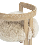 Jennifer Taylor Home Millwick low back dining arm chair in natural blonde wood with a sleek, modern design and cushioned seat.