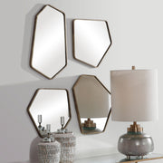 Set of four Uttermost Linneah modern gold wall mirrors with sleek frames, stylishly arranged for contemporary decor.