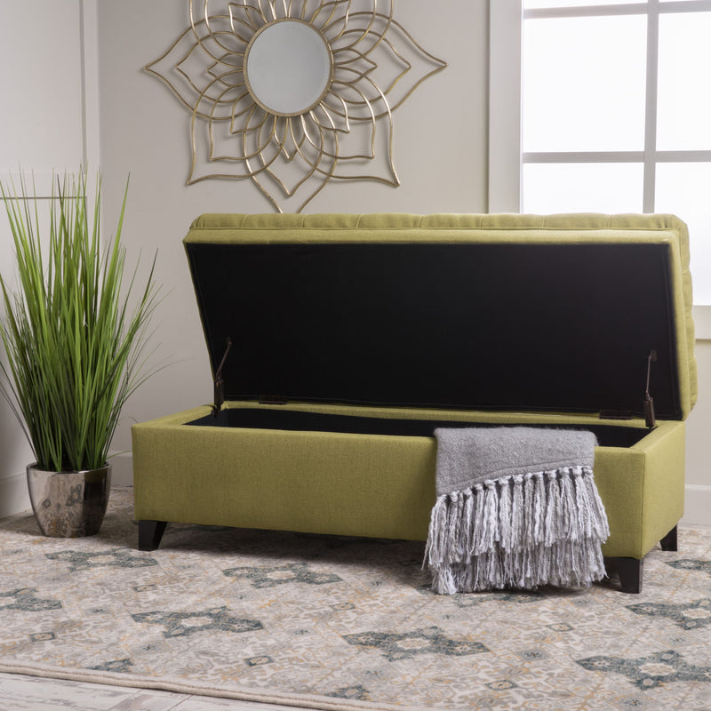 Noble House Juliana storage ottoman with birch wood legs, upholstered in fabric, serving as a versatile seating and storage piece.