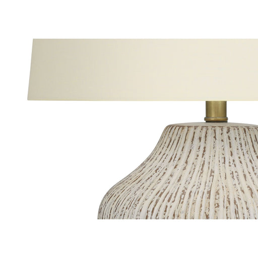 Cream ceramic transitional table lamp by 8th Street with a stylish, modern design and a smooth finish.