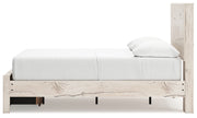Signature Design by Ashley Lawroy panel storage bed with built-in compartments and a modern wood finish in a bedroom setting.