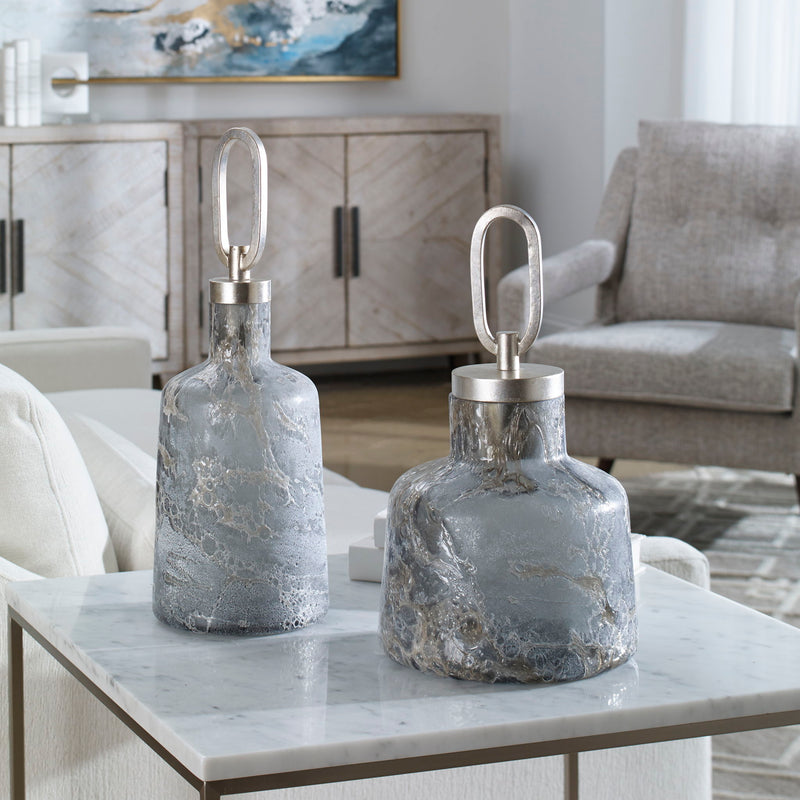 Set of two dark gray art glass bottles from Storm collection by Uttermost, decorative vases with sleek, modern design.