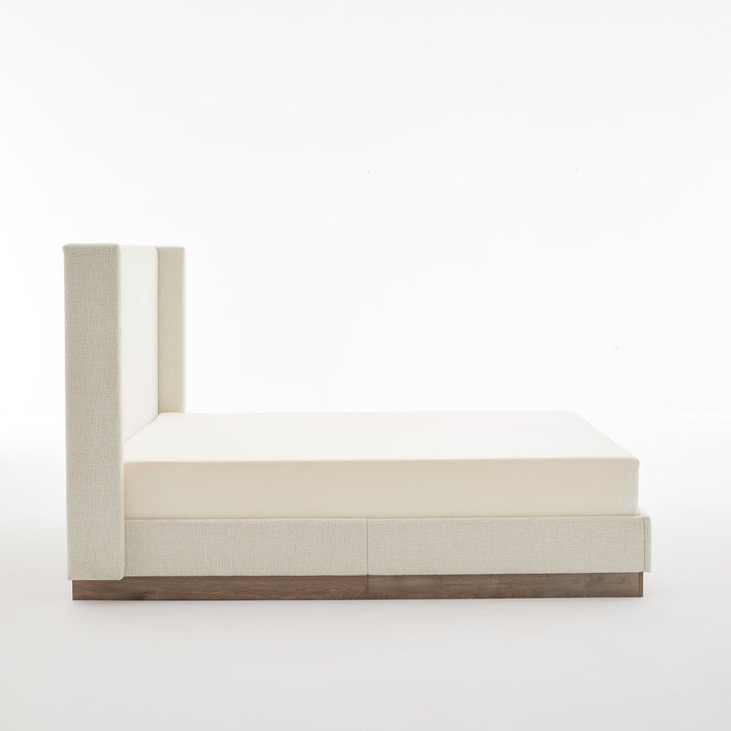 House & Home Furniture Hosford minimalist upholstered wingback bed with wood platform base, showcasing soft fabric and sleek design.