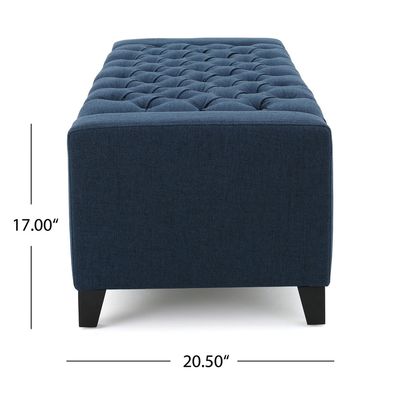 Noble House Guernsey storage ottoman with tufted top and wooden legs, used for extra seating or hidden storage in living room.