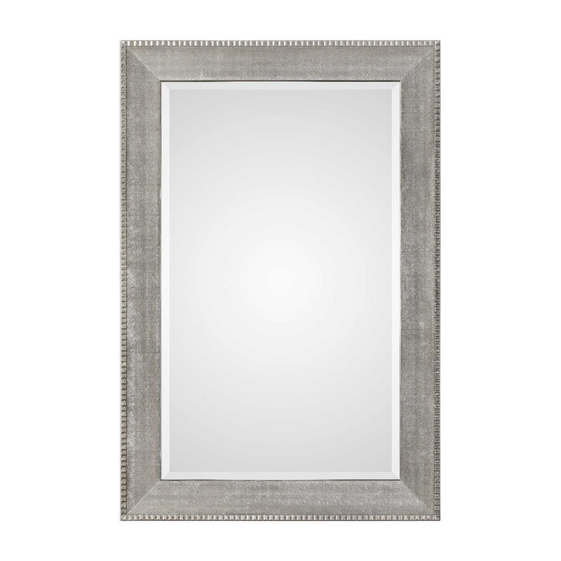 Silver metallic wall mirror with a sleek, modern frame from Uttermost Leiston collection, reflecting light and adding contemporary style.