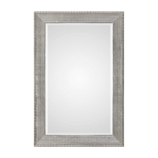 Silver metallic wall mirror with a sleek, modern frame from Uttermost Leiston collection, reflecting light and adding contemporary style.