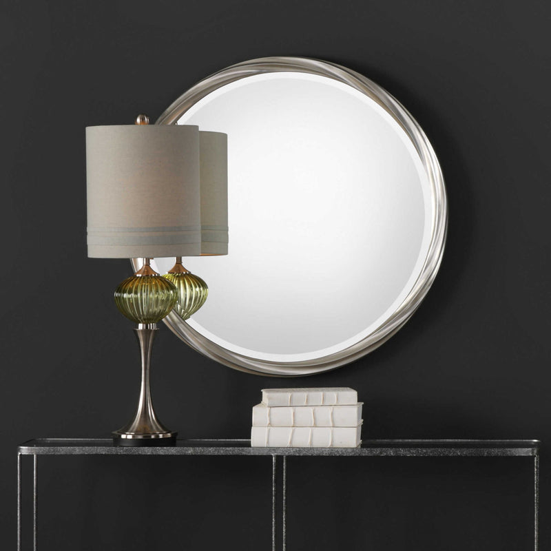 Silver Orion round wall mirror by Uttermost with a sleek, minimalist design, reflecting light in a modern space.