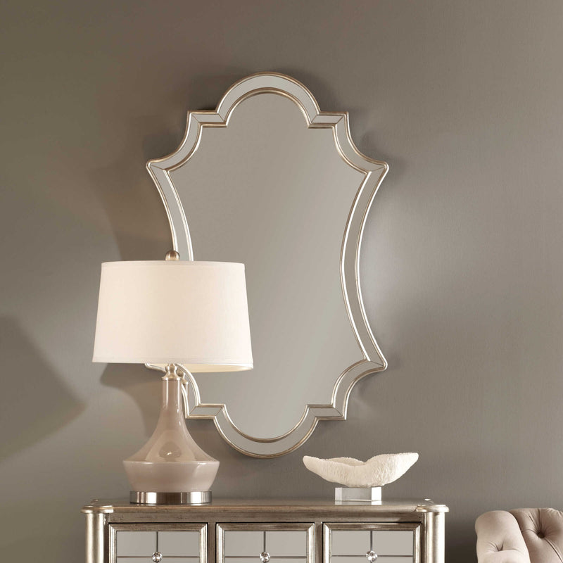 Elara wall mirror by Uttermost with antiqued silver finish, featuring a round frame and vintage-inspired design.