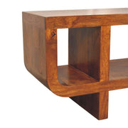 Artisan Furniture Orion curved media unit in brown with open shelves and storage compartments for TV and media accessories.