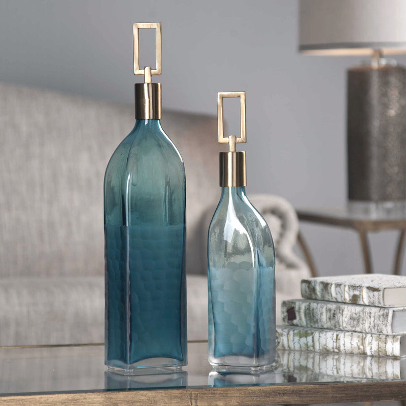 Set of two teal glass bottles from Uttermost Annabella vases, featuring elegant, rounded shapes for decorative display.